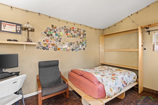 bedroom featuring baseboards and wood finished floors