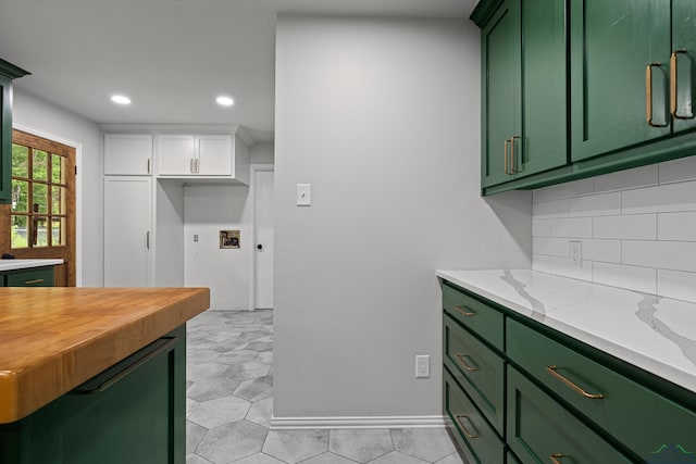 kitchen featuring recessed lighting, tasteful backsplash, white cabinetry, green cabinetry, and wooden counters