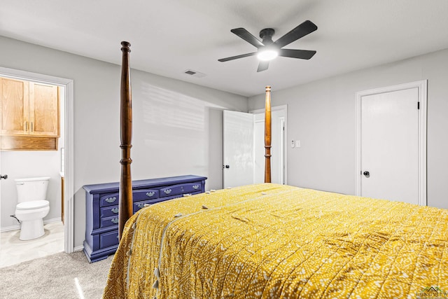 carpeted bedroom featuring baseboards, visible vents, ceiling fan, and ensuite bathroom