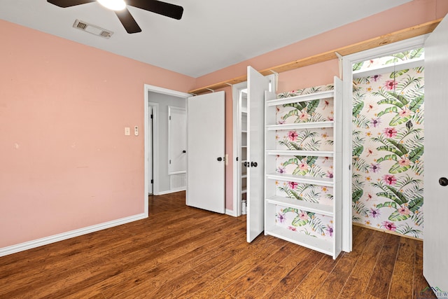 unfurnished bedroom featuring baseboards, visible vents, wood finished floors, and ceiling fan