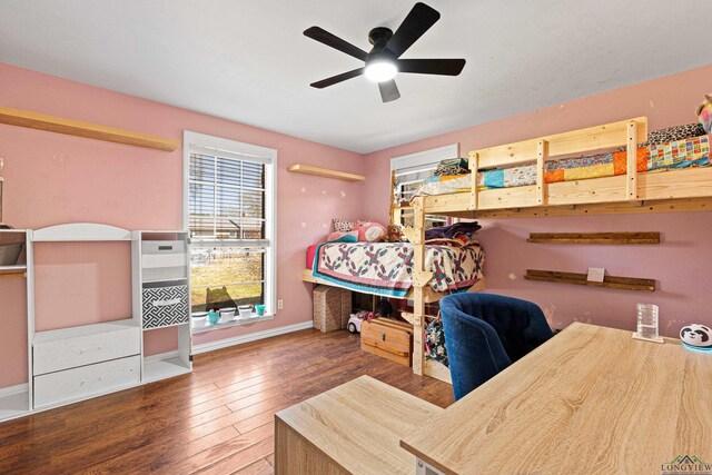 bedroom with ceiling fan, hardwood / wood-style flooring, and baseboards