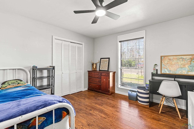 bedroom with a ceiling fan, a closet, baseboards, and wood finished floors