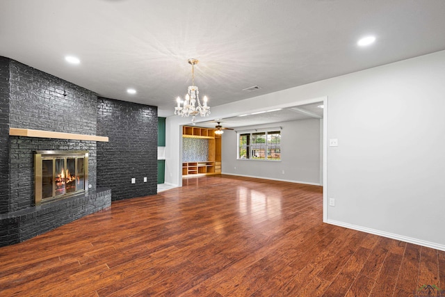 unfurnished living room featuring recessed lighting, a fireplace, visible vents, baseboards, and wood finished floors