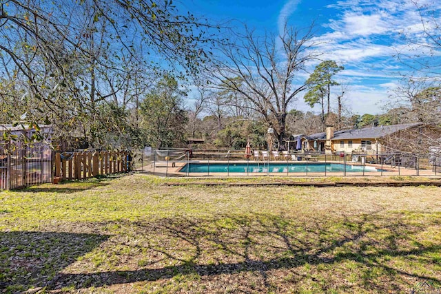 view of yard with a fenced in pool and fence