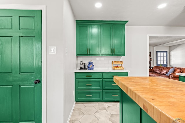 kitchen with light tile patterned floors, recessed lighting, butcher block counters, backsplash, and green cabinetry