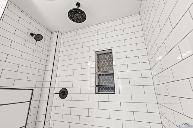 bathroom with tiled shower