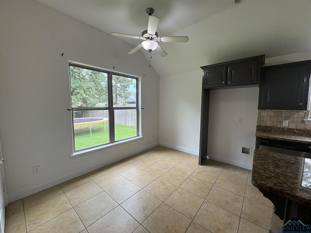 kitchen featuring ceiling fan, tasteful backsplash, light tile patterned floors, and vaulted ceiling