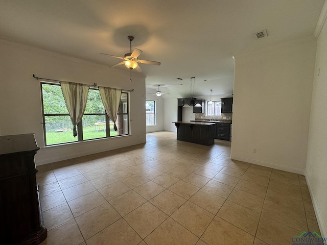 unfurnished living room featuring ceiling fan and light tile patterned floors