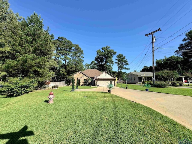 view of front of home featuring a garage and a front lawn