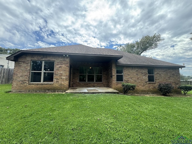 back of house with a lawn and a patio area