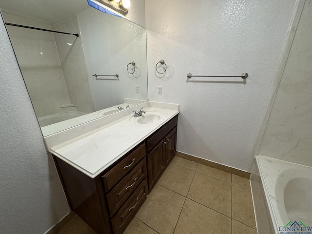 bathroom with tile patterned flooring, vanity, and a tub