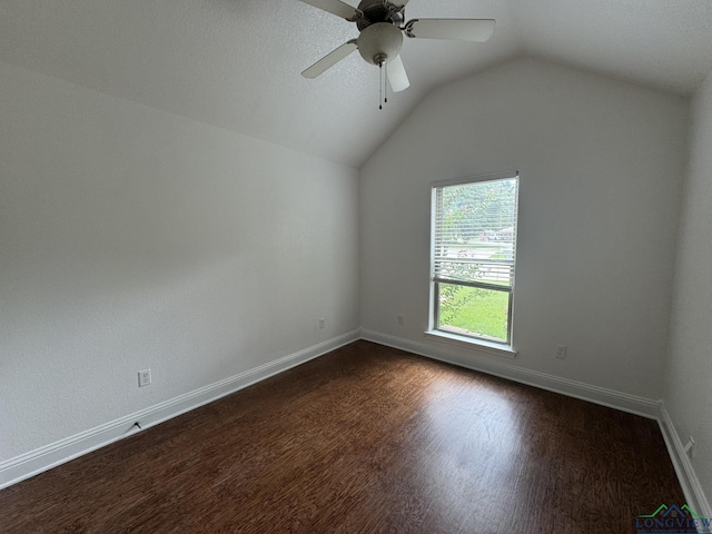 empty room with ceiling fan, dark hardwood / wood-style flooring, and lofted ceiling