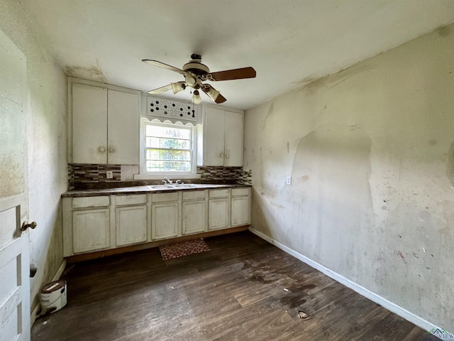 313 Millie St, Longview, TX 75602 - kitchen with a ceiling fan, dark wood finished floors, dark countertops, and cream cabinetry