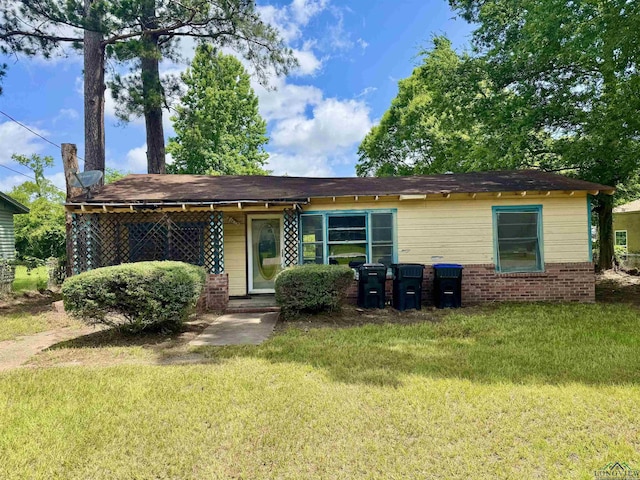 313 Millie St, Longview, TX 75602 - back of property featuring a yard, a chimney, and brick siding