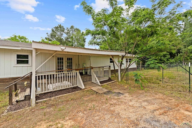 back of house with fence and french doors
