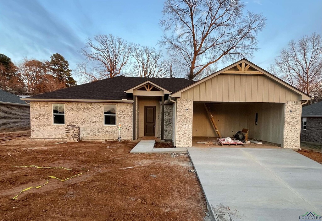 ranch-style house with brick siding, driveway, and an attached garage