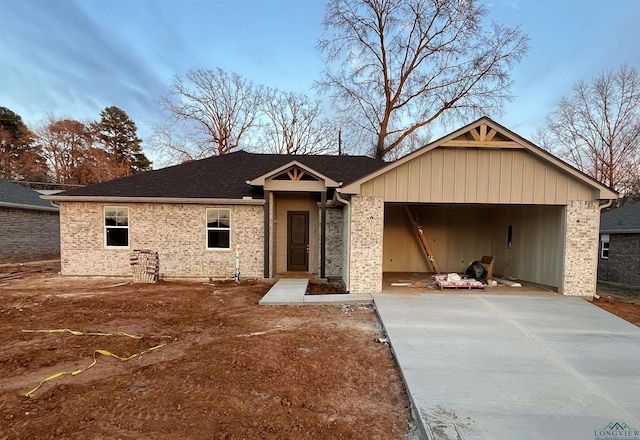 ranch-style house with brick siding, driveway, and an attached garage