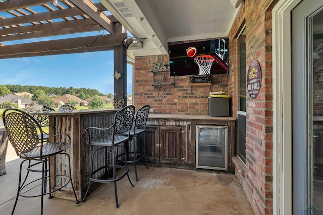 view of patio / terrace featuring a pergola, wine cooler, and exterior bar