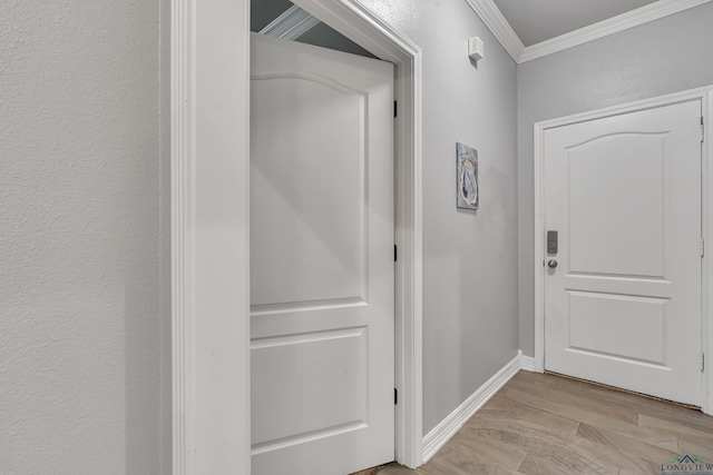 hall with light wood-type flooring and ornamental molding