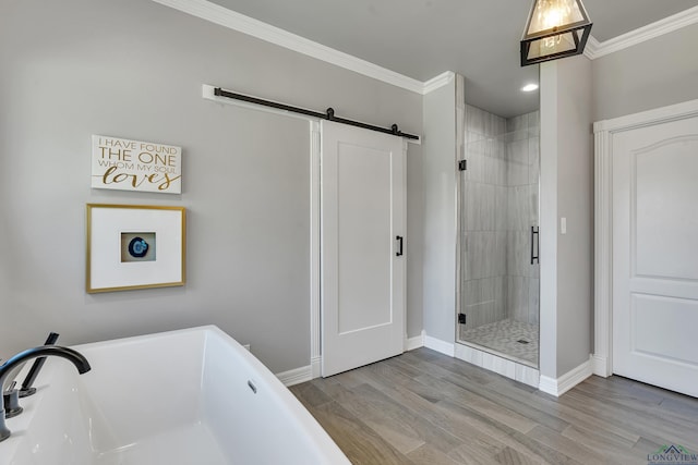 bathroom with separate shower and tub, wood-type flooring, and ornamental molding