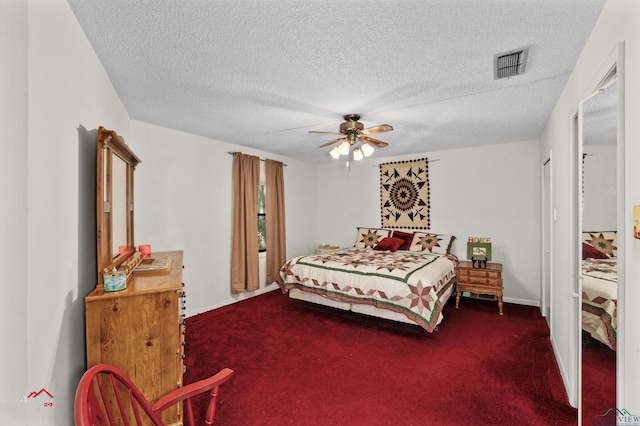 carpeted bedroom with ceiling fan and a textured ceiling