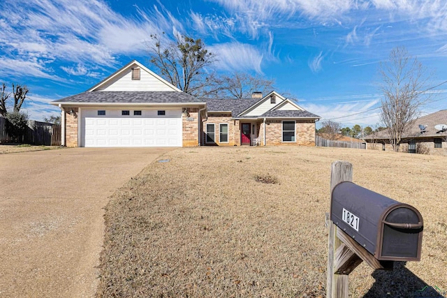 ranch-style house featuring a garage and a front yard