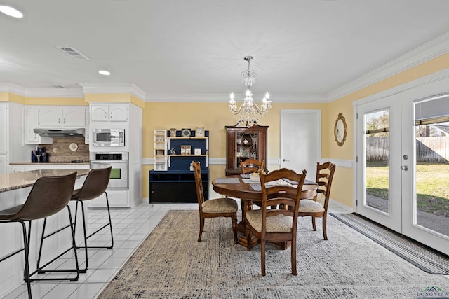 dining area featuring ornamental molding, french doors, a chandelier, and light tile patterned flooring