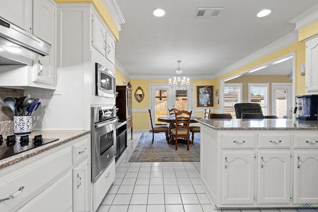 kitchen with stainless steel appliances, white cabinetry, light tile patterned floors, and crown molding