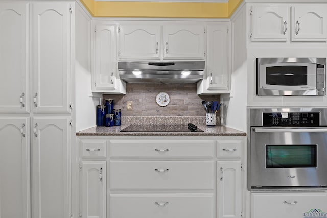 kitchen with white cabinetry, appliances with stainless steel finishes, and range hood