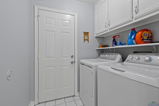 washroom with independent washer and dryer, light tile patterned floors, and cabinets