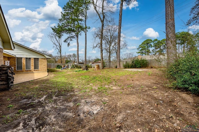 view of yard with a fenced backyard and a playground