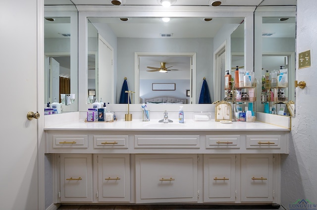 bathroom with vanity, visible vents, and ensuite bathroom