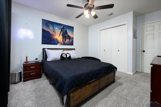 carpeted bedroom with a ceiling fan, visible vents, and a closet