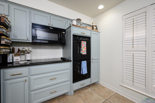 kitchen featuring light tile patterned floors, recessed lighting, black appliances, tasteful backsplash, and dark stone countertops