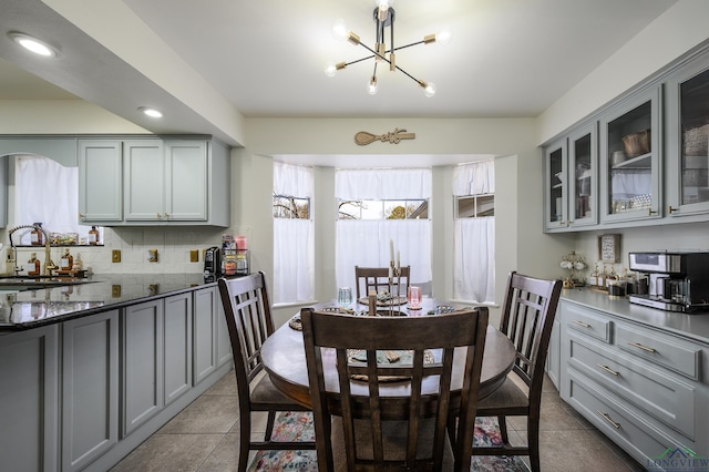 dining area featuring an inviting chandelier, light tile patterned floors, and recessed lighting