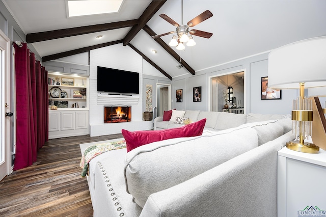 living room featuring lofted ceiling with beams, ceiling fan, a fireplace, and dark wood-style floors