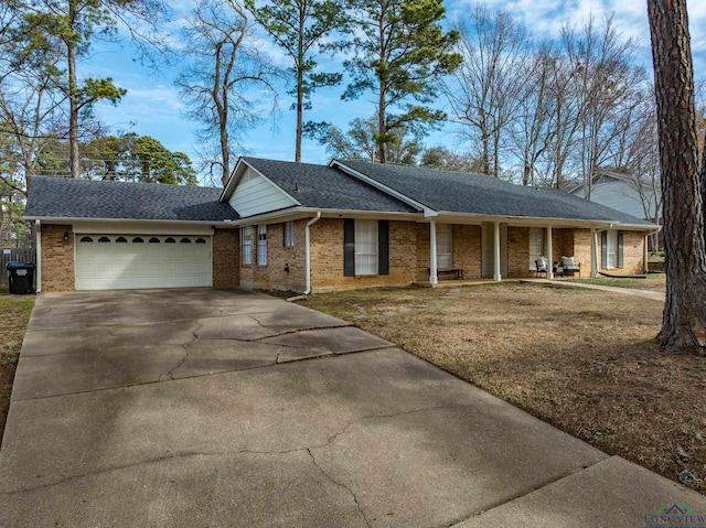 single story home featuring roof with shingles, brick siding, a garage, driveway, and a front lawn