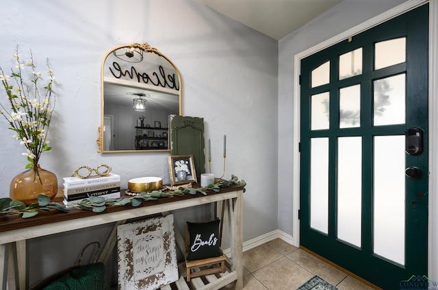 tiled entrance foyer with baseboards