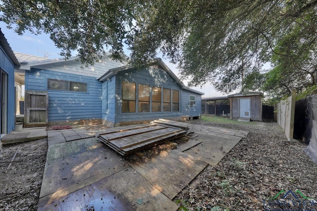 back of property featuring a patio area and a storage shed