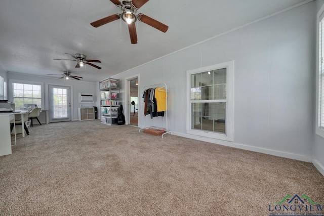 unfurnished living room with crown molding and carpet floors