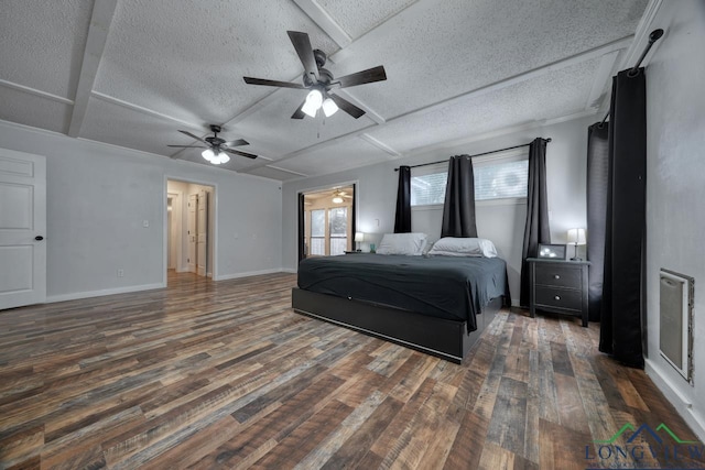 bedroom featuring dark hardwood / wood-style flooring, ceiling fan, and a textured ceiling