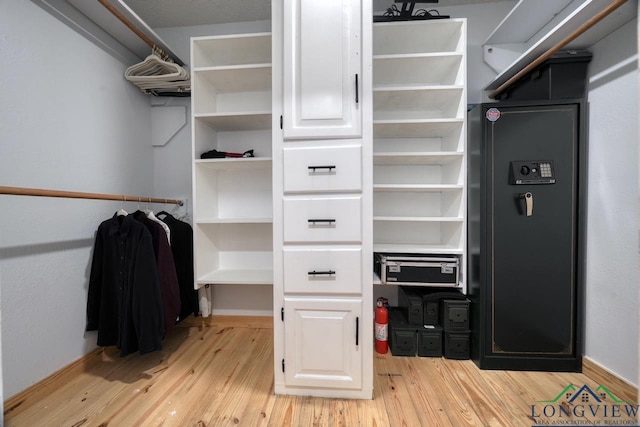 walk in closet featuring light hardwood / wood-style flooring