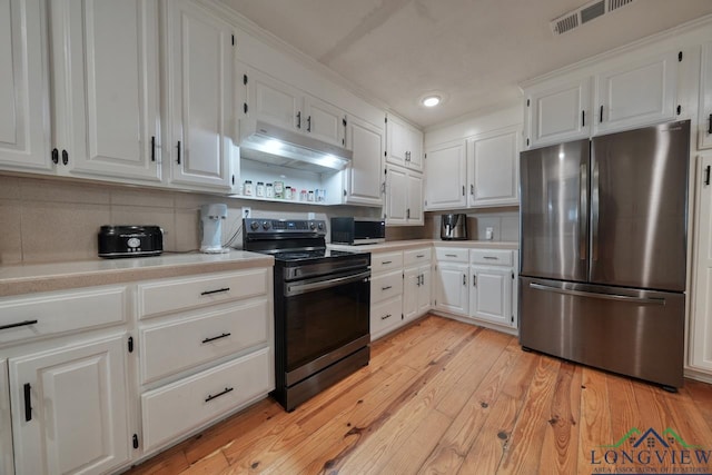 kitchen featuring tasteful backsplash, stainless steel appliances, light hardwood / wood-style floors, and white cabinets