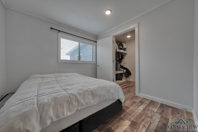 bedroom with dark wood-type flooring and ornamental molding