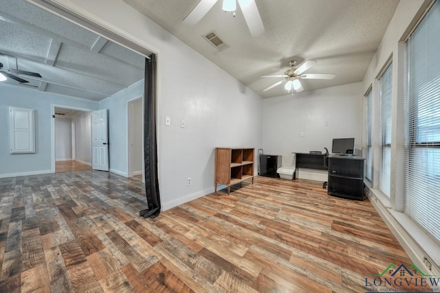 unfurnished office featuring hardwood / wood-style flooring, ceiling fan, and a textured ceiling