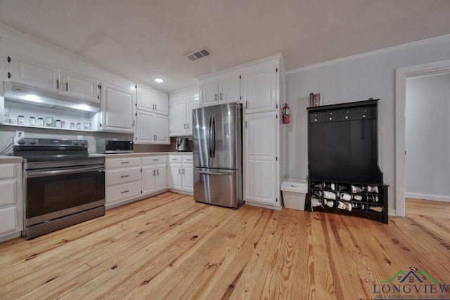 kitchen featuring white cabinetry, ornamental molding, appliances with stainless steel finishes, and light hardwood / wood-style floors