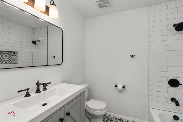 full bathroom with toilet, vanity, and tiled shower / bath combo