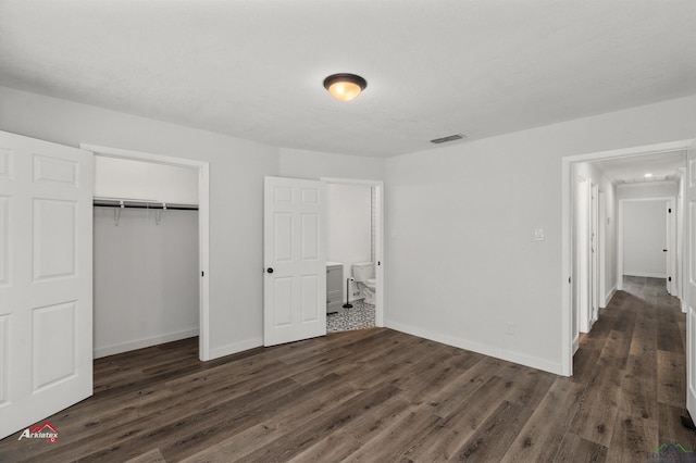 unfurnished bedroom with a closet and dark hardwood / wood-style flooring