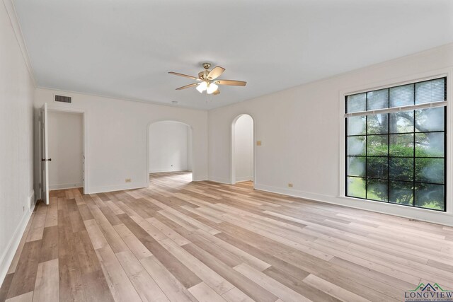 spare room with ceiling fan, light wood-type flooring, and crown molding