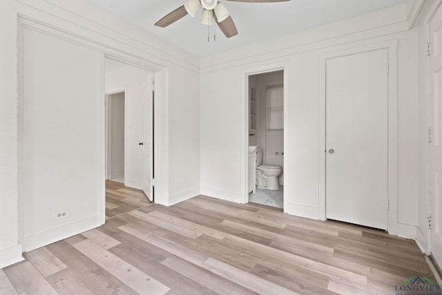 unfurnished bedroom featuring ensuite bathroom, ceiling fan, and light wood-type flooring